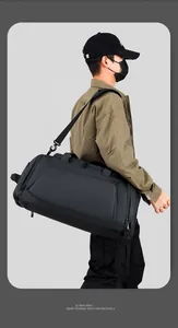 Macro side view of a large black waterproof fitness bag with adjustable wide shoulder straps