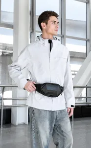 Detail of hard shell chest bag with carbon fiber texture worn with casual jacket