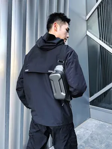 Detail of hard shell crossbody bag with carbon fiber texture and metallic finish