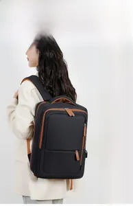 Detail of travel backpack showing side USB charging port and brown zipper pullers