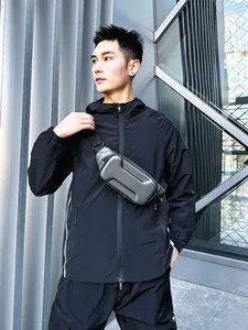 Hard shell motorcycle chest bag with carbon fiber texture worn in an urban techwear style