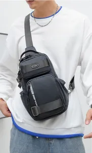 Detail of dark grey tactical chest bag with dual zipper pockets and side mesh holder