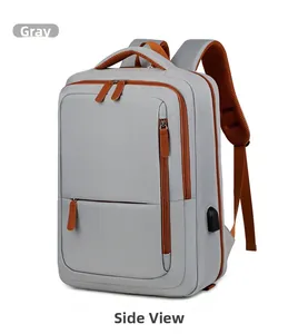 Close-up of grey travel backpack with orange accents and integrated USB charging port
