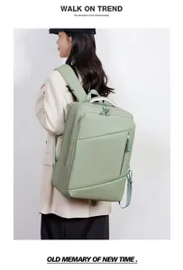 Mint green expandable travel laptop backpack shown on model with ergonomic shoulder straps