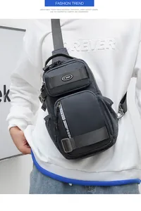 Detail view of large capacity dark grey Oxford chest bag on a model in casual white outfit