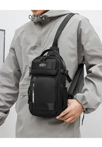Detailed view of a black multi-pocket crossbody chest bag shown on a male model outdoors