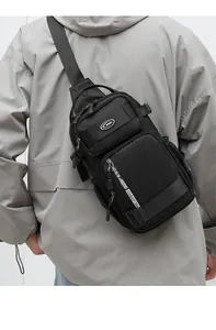 Macro view of black oxford fabric sling bag with zip compartments and sport logo
