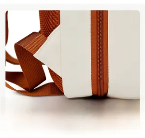 Close-up of reinforced triangle stitching on the travel backpack strap and mesh fabric