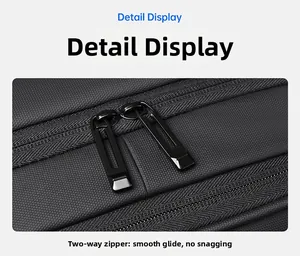 Detail display of smooth black metal two-way zipper on textured fabric backpack