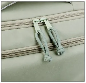 Detail of high-quality SBS two-way metal zippers with long pullers on the green backpack