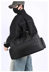 Große schwarze Reisetasche mit weißen Nähten am Model auf weißem Hintergrund präsentiert