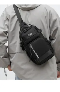 Detailed view of black tactical chest bag with functional zippers and sports logo on nylon