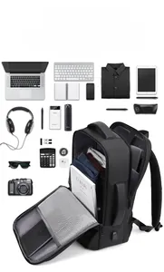 Flat lay of black business travel backpack with laptop compartment and USB charging port