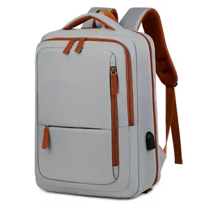 Light grey travel backpack with orange-brown trim and external USB charging port