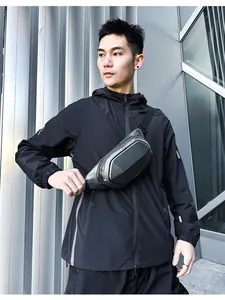 Close-up of black hard-shell chest bag with carbon fiber texture in outdoor lifestyle setting