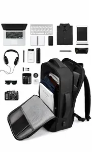 Flat lay of large capacity business backpack with laptop compartment and travel gear