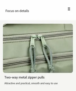 Close-up of premium two-way metal zippers and sage green nylon fabric on travel backpack