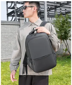 Outdoor shot of a black waterproof business backpack worn by a male model for commute