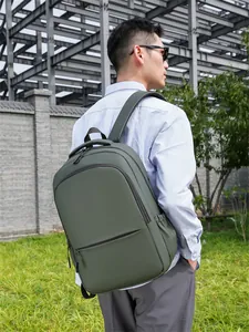 Detail view of water-resistant deep green business backpack with padded straps and side pockets