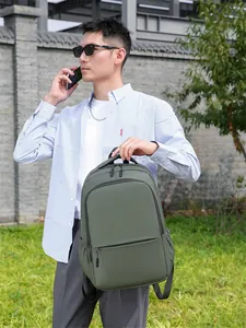Close-up of olive green waterproof laptop backpack with dual zippers and durable top handle