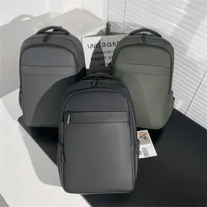 Business backpacks in black, grey, and green colors made of water-resistant material