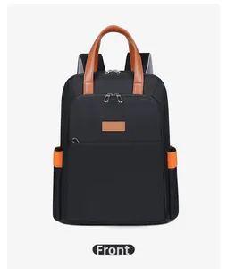 Front view detail of a black laptop backpack with brown leather handle and silver zippers