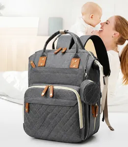 Detailed view of gray multi-functional diaper backpack with diamond-quilted stitching pattern