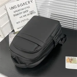 Detail view of water-resistant black business backpack with multi-layer zipper compartments