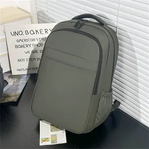 Detail view of water-resistant matte nylon laptop backpack in dark green with side pocket