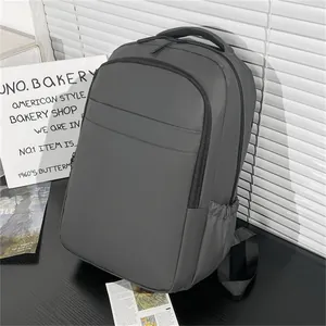 Detail view of the deep gray water-resistant laptop backpack with side pocket and carry handle