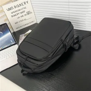 Close-up of black water-resistant business backpack with multi-layer zipper compartments