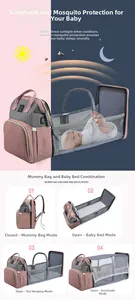 Pink and grey diaper bag showing its multifunctional conversion into a folding baby crib