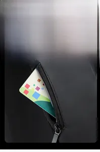 Close-up of black crossbody bag strap featuring a zipper pocket for quick card access