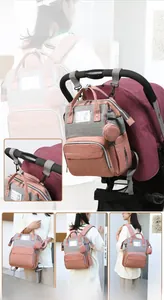 Close-up of pink and grey diaper bag with stroller hooks and multi-functional carrying straps