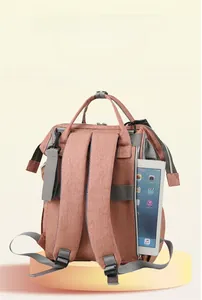 Detail of coral pink backpack showing back zipper pocket with a tablet storage compartment