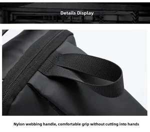 Close-up of durable nylon webbing handle on a black waterproof anti-theft sling bag
