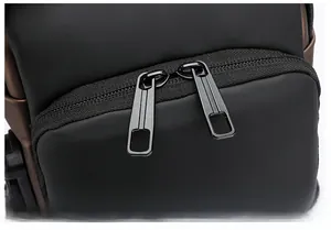 Detail of durable dual metal zippers and smooth closure on black matte motorcycle bag