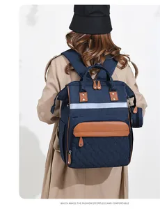 Detail of navy canvas backpack with reflective strip and brown leather accents