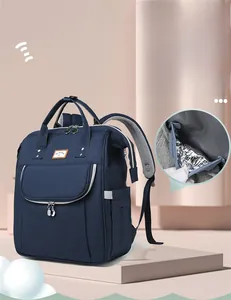 Detail of independent insulated bottle pocket on large capacity blue diaper backpack