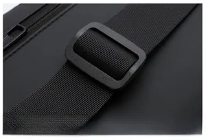 Detail of adjustable black shoulder strap with durable plastic buckle and waterproof fabric