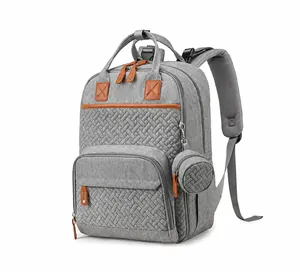 Detail of grey multifunctional diaper backpack with brown leather accents and a small round pouch