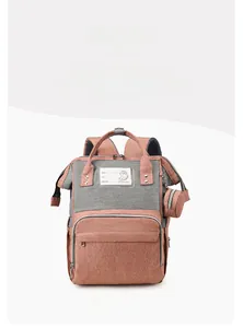Front view of pink and grey diaper backpack with storage pouch and signature label