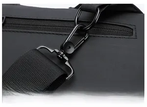 Macro detail of black metal D-ring and swivel buckle on crossbody sling bag strap