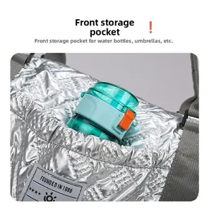 Close-up of front pocket on quilted silver travel bag showing elastic storage for essentials