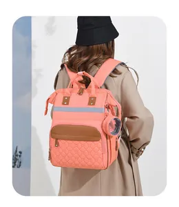 Detail view of pink diaper backpack with quilted heart pocket and safety reflective strip