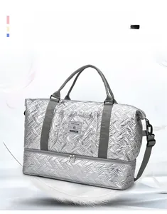 Silver quilted travel bag showing separate bottom compartment for shoes and light design