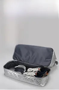 Macro view of travel bag bottom featuring an independent shoe compartment for storage