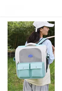 Detail view of breathable mesh and front pockets on a mint green pet backpack carrier