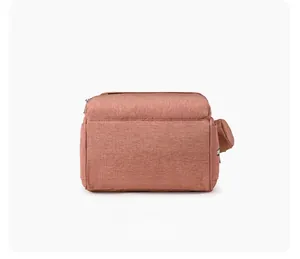 Bottom view of pink multifunctional diaper bag showing texture and side attachment