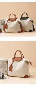 Detail of canvas travel bag with leather trim and adjustable shoulder strap